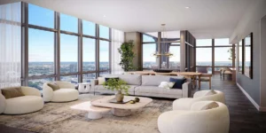 Penthouses with Modern living room with large windows, city view, neutral-toned furnishings, round chairs, a gray sofa, coffee table, plants, and a dining area in the background.