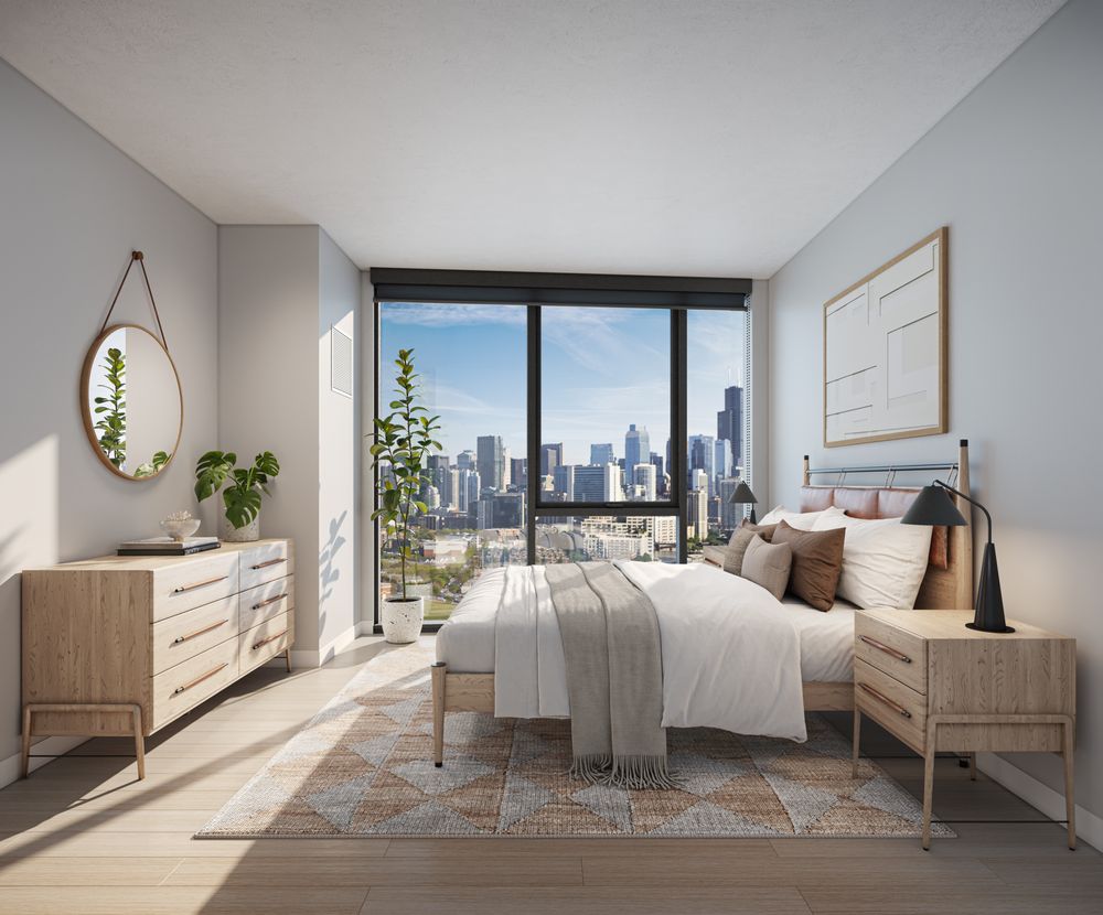 Modern bedroom with wooden furniture, large windows, and a city skyline view. Room is bright with neutral decor, indoor plants, and framed wall art.
