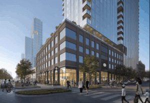 People walk and ride bikes near a modern multi-story building with glass windows on a city street corner, surrounded by high-rise structures.