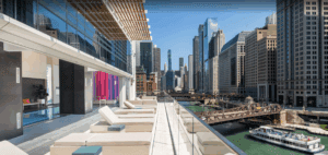 A balcony with a view of a city and a river.