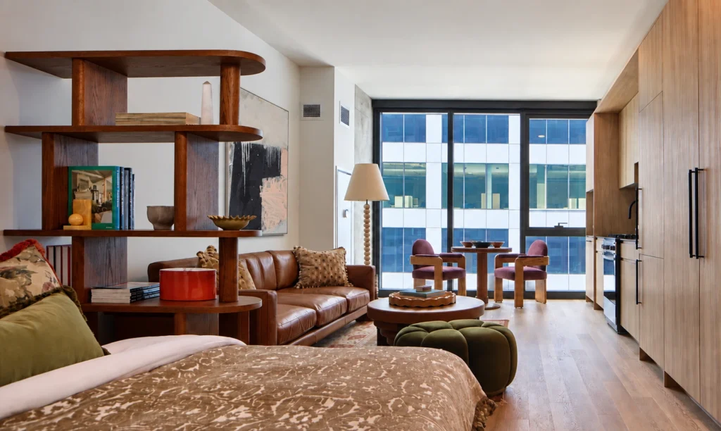 Luxury Chicago Downtown Apartments for Rent. Stead 220 Chicago Apartments. 220 North Ada Street open shelving, dining table, and kitchenette, featuring large windows and contemporary decor.